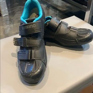 Shimano size 40 spin shoes with cleats attached .